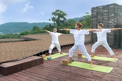 a group of people doing yoga on a roof at Keemala in Kamala Beach