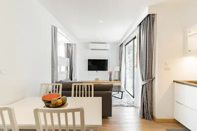 a living room with a couch and a table at Large condo Surin-Bangtao Beach in Surin Beach