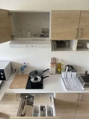 a small kitchen with a stove and a sink at Studio surin-bangtao beach in Surin Beach