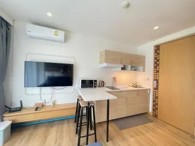 a kitchen with a counter and a table in a room at Studio surin-bangtao beach in Surin Beach