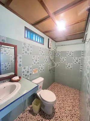 a bathroom with a toilet and a sink at Phi Phi Treetop in Phi Phi Don