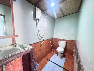 a bathroom with a toilet and a shower at Phi Phi Treetop in Phi Phi Don