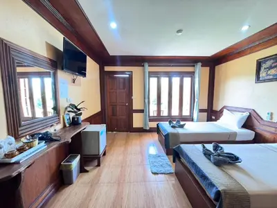 a room with two beds and a tv in it at Phi Phi Treetop in Phi Phi Don