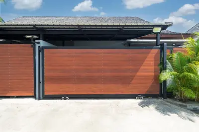 a wooden gate in front of a house at Vanille Villa in Balinese style with swimming pool in Ban Saiyuan (1)