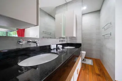 a bathroom with two sinks and a black counter at Vanille Villa in Balinese style with swimming pool in Ban Saiyuan (1)