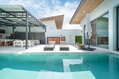 a house with a swimming pool and a patio at Vanille Villa in Balinese style with swimming pool in Ban Saiyuan (1)