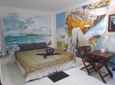 a room with a bed and a painting on the wall at Reggaein in Phi Phi Don