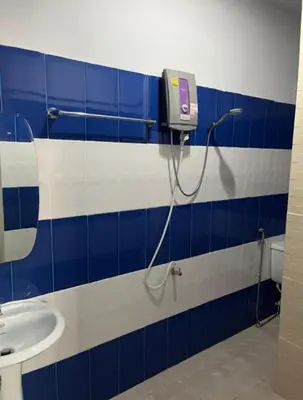 a bathroom with a blue and white tiled wall at Reggaein in Phi Phi Don