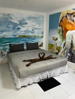a bedroom with a large bed with a monkey on it at Reggaein in Phi Phi Don