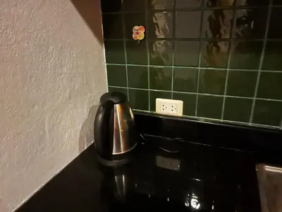 a bathroom with a black sink and green tiles at Thebirdhouse Patong Phuket303 in Patong Beach