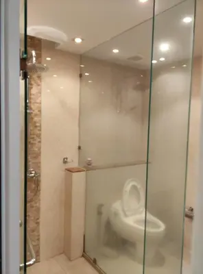 a bathroom with a glass shower with a toilet at Thebirdhouse Patong Phuket303 in Patong Beach