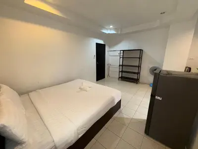 a small bedroom with a bed and a ladder in it at Patong Canal Villa 101 in Patong Beach