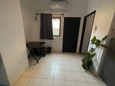 a hallway with a door and a table and a window at Patong Canal Villa 101 in Patong Beach