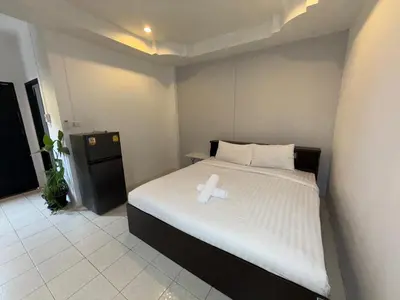 a bedroom with a bed with a cross on it at Patong Canal Villa 101 in Patong Beach