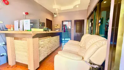 a salon with a white couch at a counter at Hill Side Patong Hotel in Patong Beach