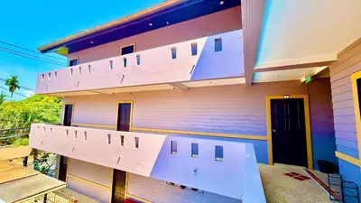 a building with a staircase on the side of it at Hill Side Patong Hotel in Patong Beach