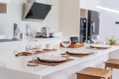 a kitchen counter with wine glasses and plates on it at Exclusive 4BR Pool Designer Villa in Lux Pride 2 V6 Residence, Near Laguna in Bang Tao Beach