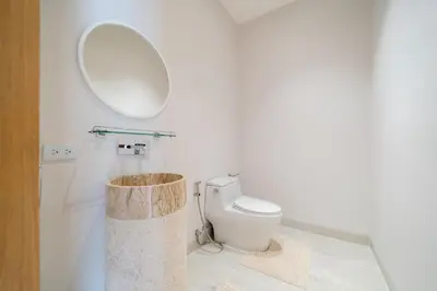 a bathroom with a toilet and a mirror at Exclusive 4BR Pool Designer Villa in Lux Pride 2 V6 Residence, Near Laguna in Bang Tao Beach