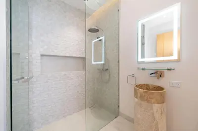 a bathroom with a shower with a glass door at Exclusive 4BR Pool Designer Villa in Lux Pride 2 V6 Residence, Near Laguna in Bang Tao Beach