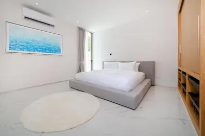 a white bedroom with a bed and a rug at Exclusive 4BR Pool Designer Villa in Lux Pride 2 V6 Residence, Near Laguna in Bang Tao Beach