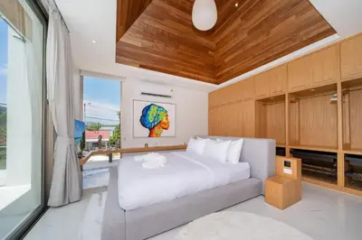 a bedroom with a white bed and a window at Exclusive 4BR Pool Designer Villa in Lux Pride 2 V6 Residence, Near Laguna in Bang Tao Beach