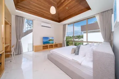 a bedroom with a large bed and a large window at New Build Masterpiece with Private Pool - 4BR Villa in Lux Pride 2 V7 Residence in Bang Tao Beach