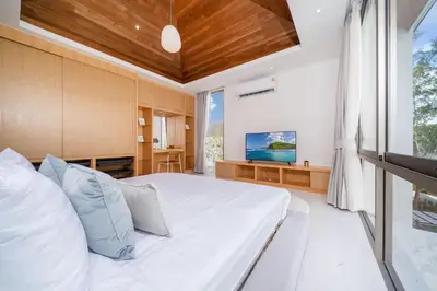 a bedroom with a large bed and a television at New Build Masterpiece with Private Pool - 4BR Villa in Lux Pride 2 V7 Residence in Bang Tao Beach