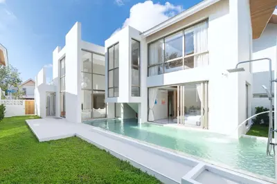 an exterior view of a white house with a swimming pool at New Elegance & Tropical Luxury - 4BR Pool Villa in Lux Pride 2 V8 Residence, near Laguna in Bang Tao Beach
