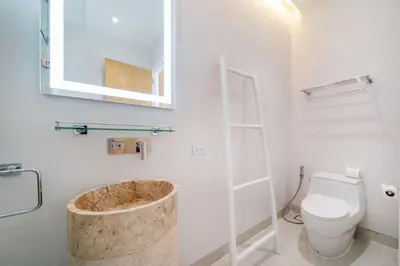 a bathroom with a toilet and a wooden tub at New Elegance & Tropical Luxury - 4BR Pool Villa in Lux Pride 2 V8 Residence, near Laguna in Bang Tao Beach