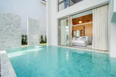an infinity pool in a house with a bedroom at Your Private Piece of Paradise! 4BR Pool Villa in the New Lux Pride 2 V9 Residence in Bang Tao Beach