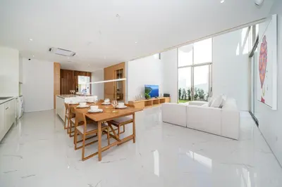 a kitchen and living room with a table and a couch at Your Private Piece of Paradise! 4BR Pool Villa in the New Lux Pride 2 V9 Residence in Bang Tao Beach