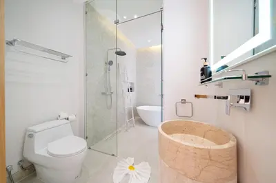 a bathroom with a toilet and a glass shower at Your Private Piece of Paradise! 4BR Pool Villa in the New Lux Pride 2 V9 Residence in Bang Tao Beach