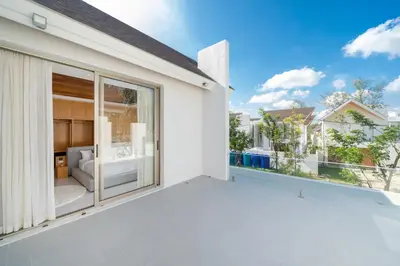 a balcony with a view of a living room at Your Private Piece of Paradise! 4BR Pool Villa in the New Lux Pride 2 V9 Residence in Bang Tao Beach