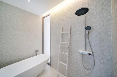 a bathroom with a shower with a white bath tub at Your Private Piece of Paradise! 4BR Pool Villa in the New Lux Pride 2 V9 Residence in Bang Tao Beach