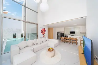 a living room with white furniture and a pool at Modern Elegance & Tropical Vibe - 4BR Pool Villa in New Build Residence Lux Pride 2 V10 in Bang Tao Beach