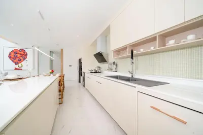 a kitchen with white cabinets and a sink at Exclusive Living in Designer 4BR Pool Villa in Lux Pride 2 V11 Residence, Near Laguna in Bang Tao Beach