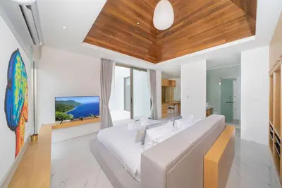a bedroom with a large white bed and a large window at Exclusive Living in Designer 4BR Pool Villa in Lux Pride 2 V11 Residence, Near Laguna in Bang Tao Beach