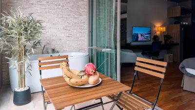 a plate of bananas on a table in a living room at Cozy studio near Bangtao Beach in Bang Tao Beach