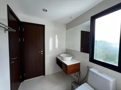a bathroom with a sink and a toilet and a window at Title III Condo Rawai, 1 bedroom in Phuket Town