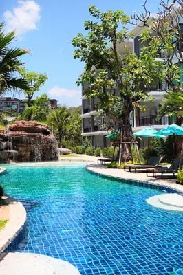 a swimming pool in front of a building at Title III Condo Rawai, 1 bedroom in Phuket Town