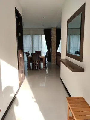 a living room with a table and a mirror at Luxury spacious 3 bdr apartment Pandora residence in Nai Harn Beach