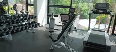 a gym with lots of exercise equipment and a window at Luxury spacious 3 bdr apartment Pandora residence in Nai Harn Beach