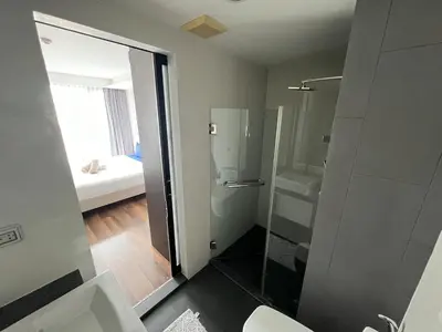 a bathroom with a shower with a glass door at Condo Surin-Bangtao Beach in Surin Beach