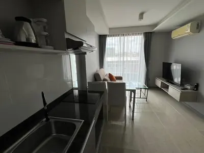 a kitchen and living room with a sink and a table at Condo Surin-Bangtao Beach in Surin Beach