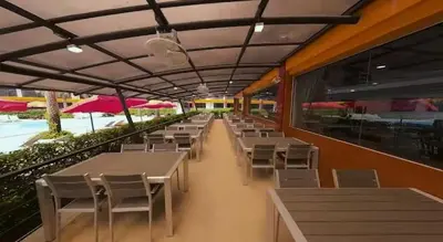 a cafeteria with tables and chairs and a pool at Skyline Retreat in Ban Mai Salae