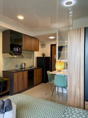a kitchen with a bed and a table and chairs at Skyline Retreat in Ban Mai Salae