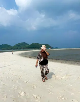 a woman walking on the beach at Patcharin Home Stay in Ko Yao Yai