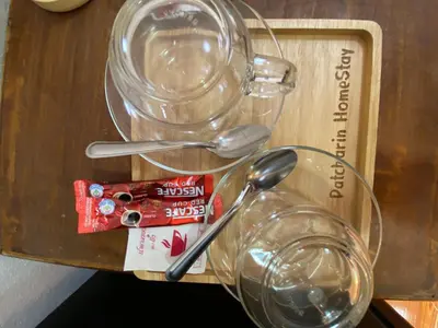 a pair of glasses and spoons on a table at Patcharin Home Stay in Ko Yao Yai
