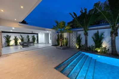a swimming pool in a house with palm trees at Diamond 1 Villa by G Estate Phuket in Ban Saiyuan (1)