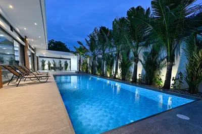 a swimming pool in a house with palm trees at Diamond 1 Villa by G Estate Phuket in Ban Saiyuan (1)